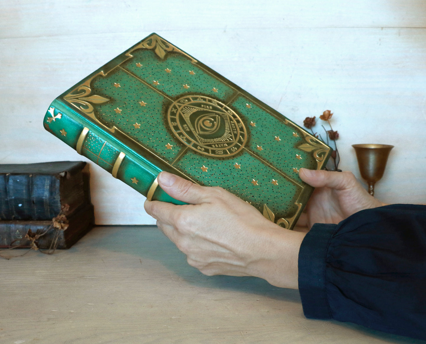 Green leather journal with gold tooled decoration, The Circle of Time
