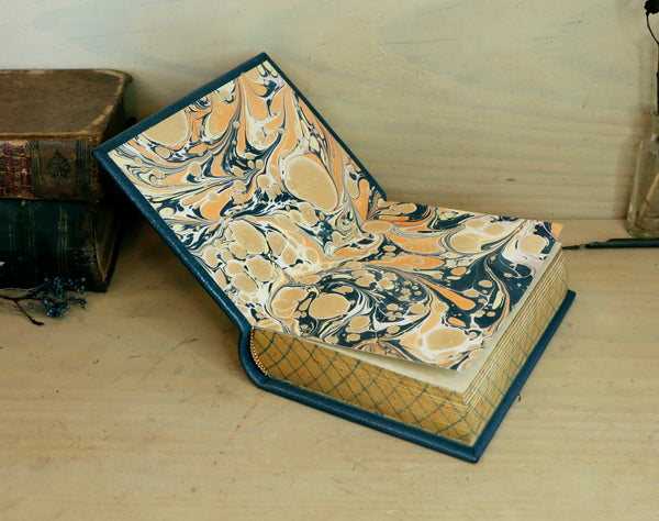 Blue leather journal with gold tooled decoration and painted edges. A Small Treasure