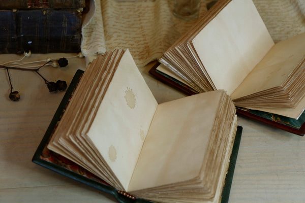 Set of 2 Small Leather Journals, Dark red and green leather with gold tooled decoration and antiqued paper. Antiquarian’s Notes