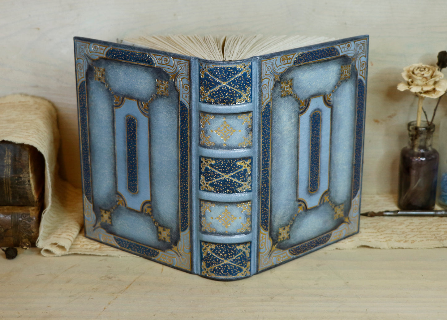 Antiqued baby blue leather journal with gold tooled decoration. Celestial Whisper