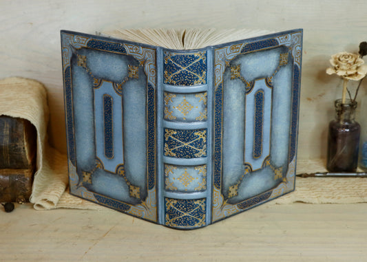 Antiqued baby blue leather journal with gold tooled decoration. Celestial Whisper