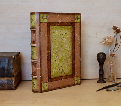 Brown leather journal with tooled and hand painted decoration. Artist paper. Mosslight
