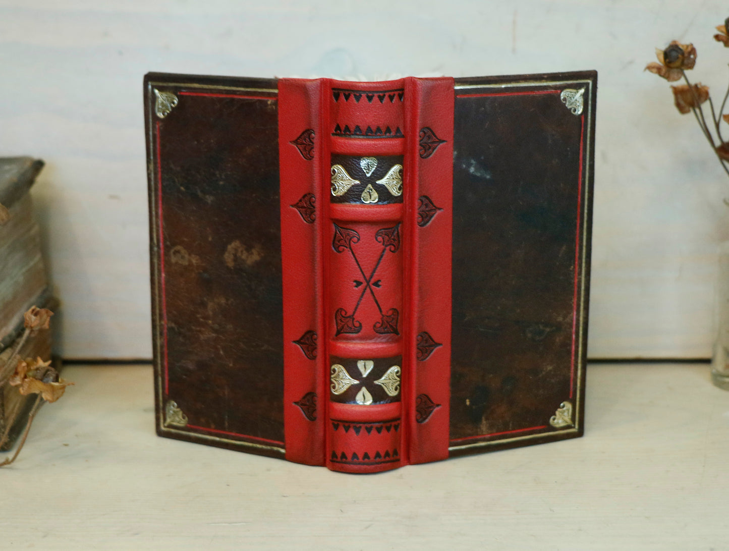 Small Vintage Journals, Brown worn leather with red spine, tooled decoration. The Vow