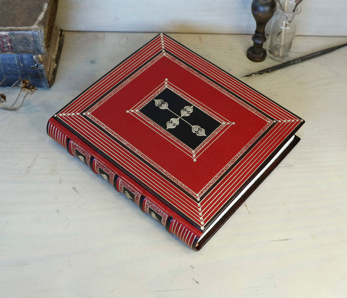 Bright red leather journal with black inlays and gold tooled decoration - The Gilded Labyrinth
