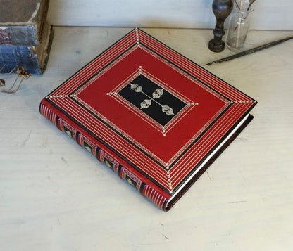 Bright red leather journal with black inlays and gold tooled decoration - The Gilded Labyrinth