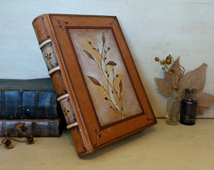 Brown leather journal with tooled floral decoration . Romantic Journey