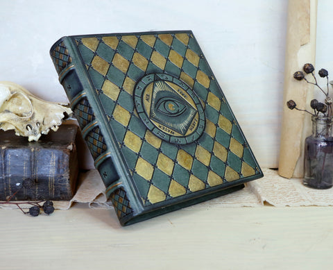 Green leather journal with gold painting and tooled decoration, The Eye of the Universe