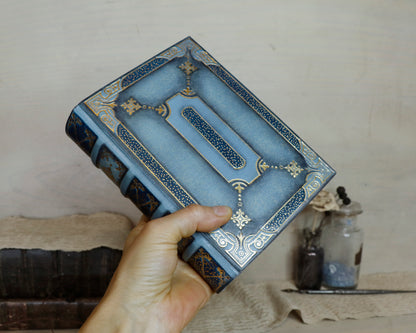 Antiqued baby blue leather journal with gold tooled decoration. Celestial Whisper
