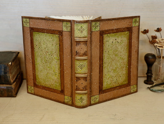 Brown leather journal with tooled and hand painted decoration. Artist paper. Mosslight