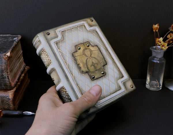 Small leather journal with brass etching of Jesus Christ, white leather with gold tooled decoration, tea stained pages