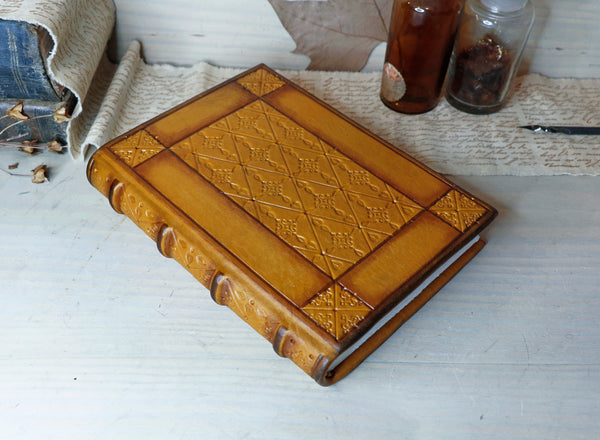 Antiqued yellow leather journal with tooled decoration. Romantic Sunset