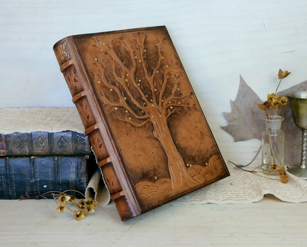 Antiqued brown leather journal with tooled decoration. The Cycle of Life