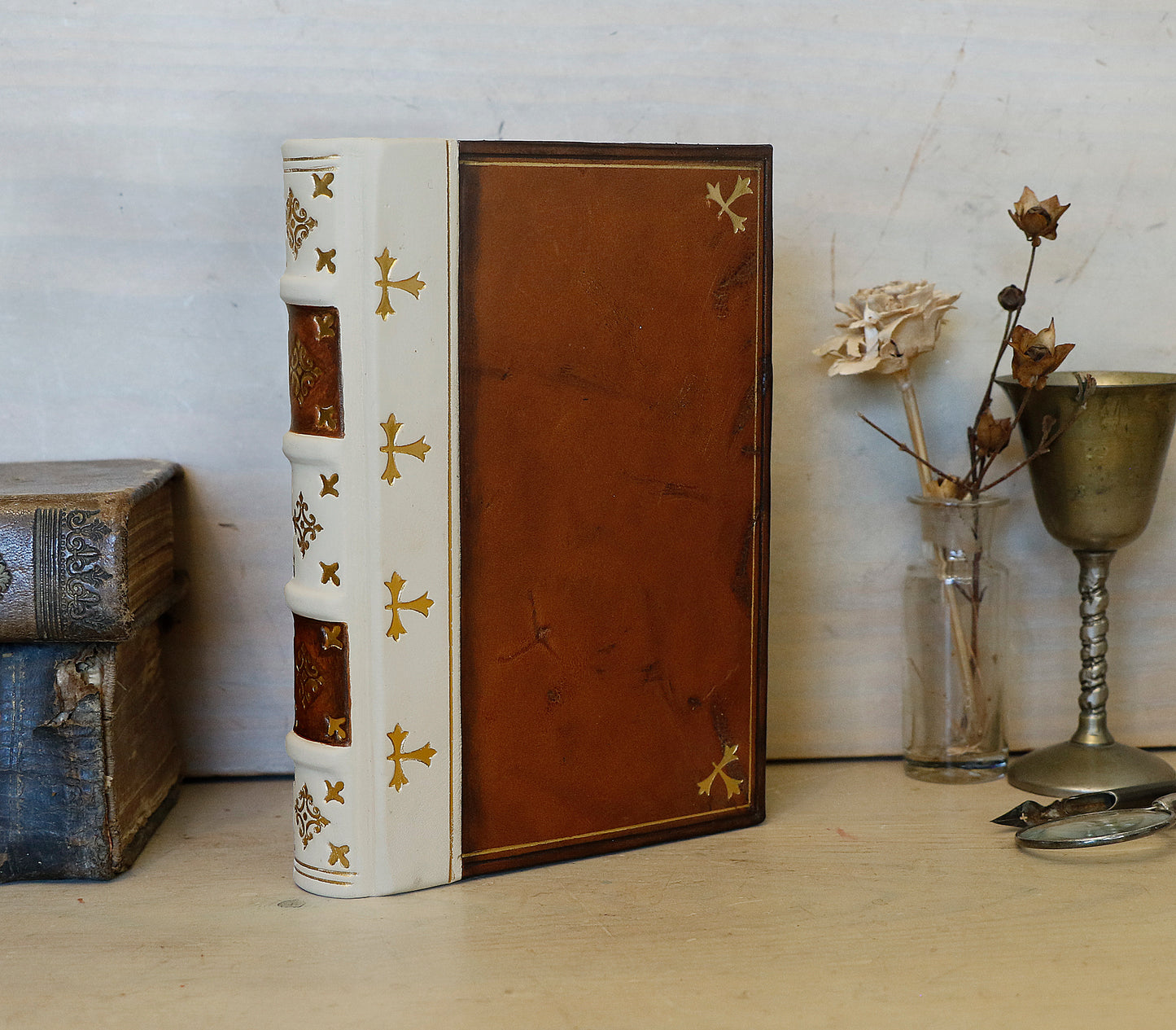 Antiqued journal, Orange-brown leather cover with white leather spine, Gold tooled decoration. The Book of Light