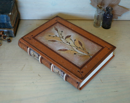 Brown leather journal with tooled floral decoration . Romantic Journey