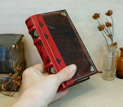 Small Vintage Journals, Brown worn leather with red spine, tooled decoration. The Vow