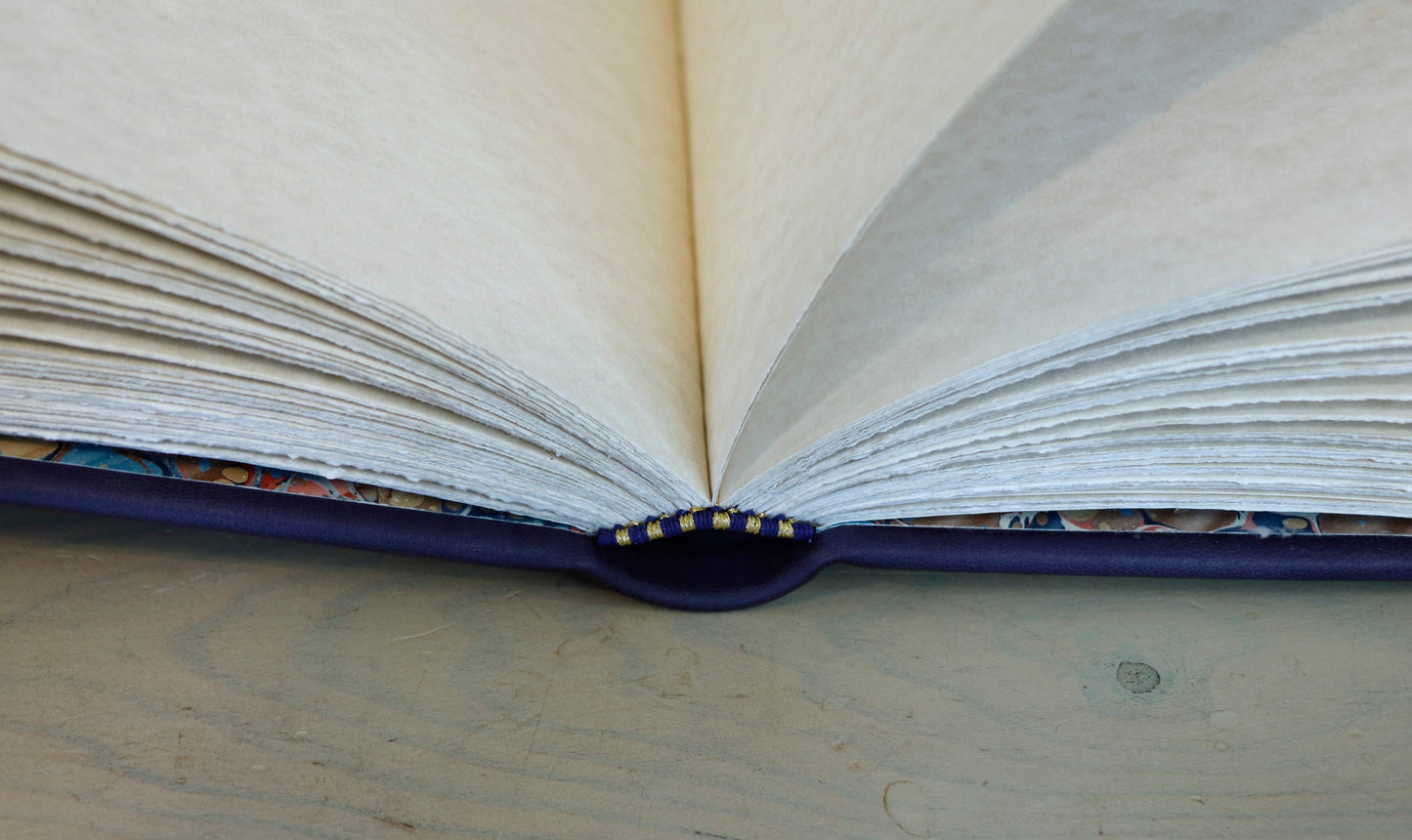 Dark blue leather journal with gold tooled decoration, The Circle of Time