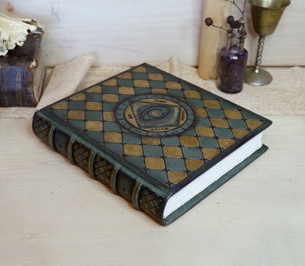 Green leather journal with gold painting and tooled decoration, The Eye of the Universe