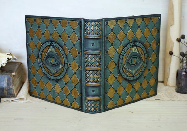Green leather journal with gold painting and tooled decoration, The Eye of the Universe