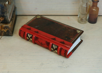 Small Vintage Journals, Brown worn leather with red spine, tooled decoration. The Vow