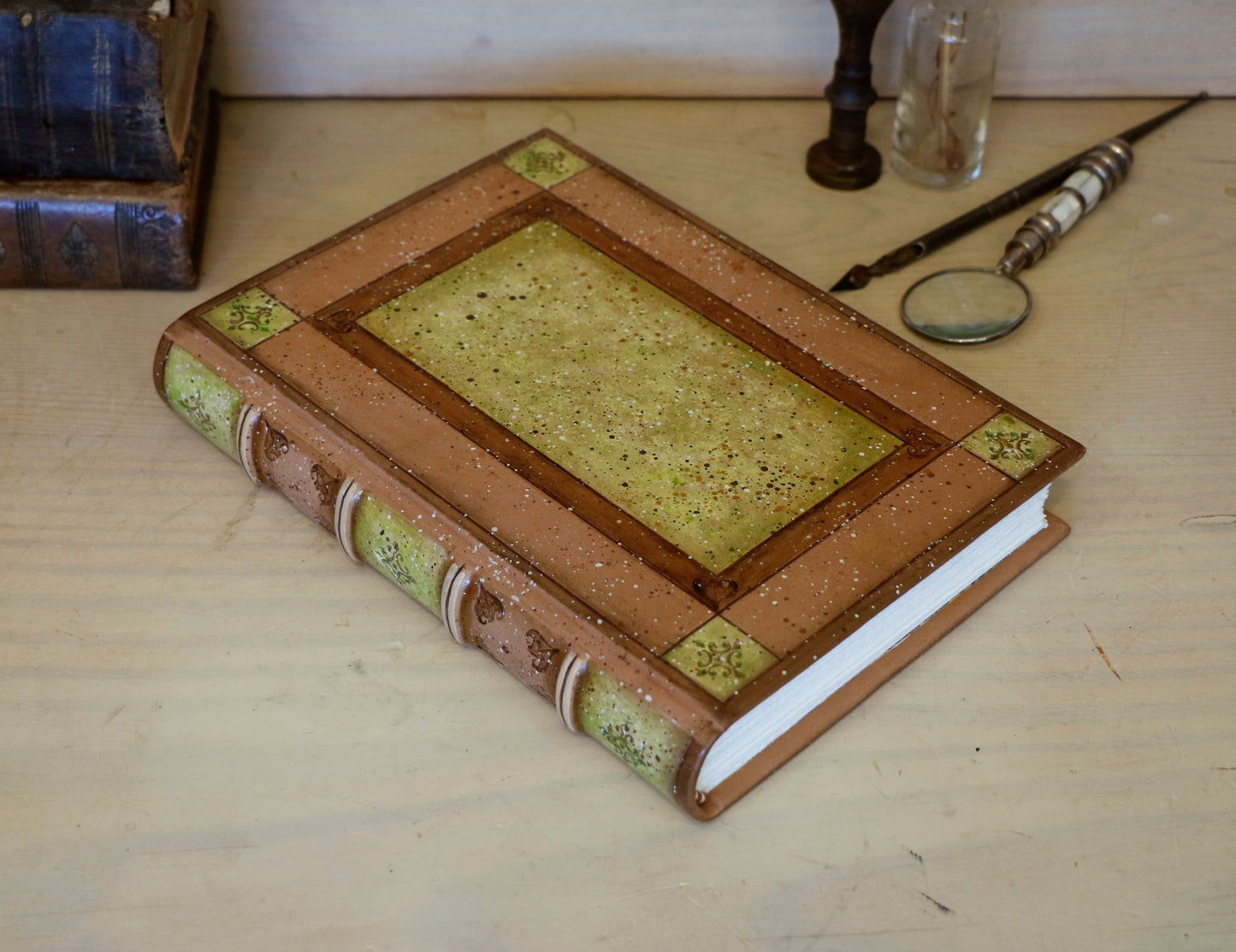 Brown leather journal with tooled and hand painted decoration. Artist paper. Mosslight