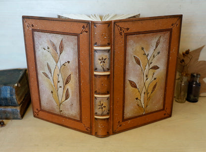 Brown leather journal with tooled floral decoration . Romantic Journey