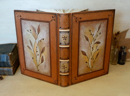Brown leather journal with tooled floral decoration . Romantic Journey