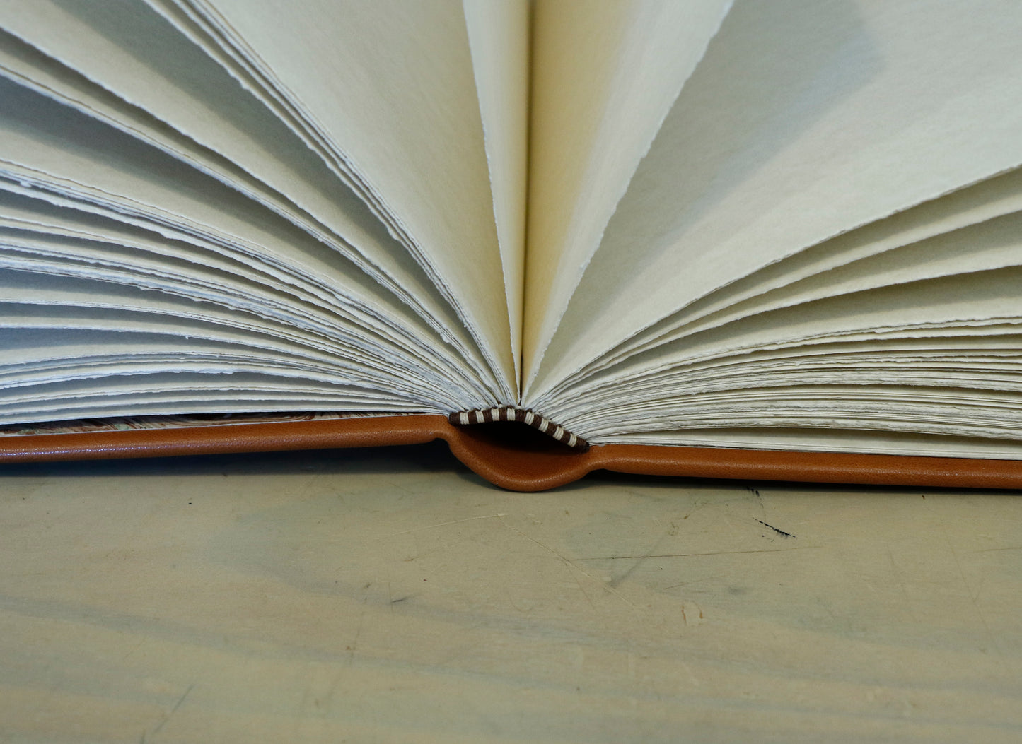 Brown leather journal with tooled floral decoration . Romantic Journey