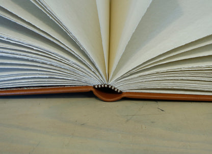 Brown leather journal with tooled floral decoration . Romantic Journey