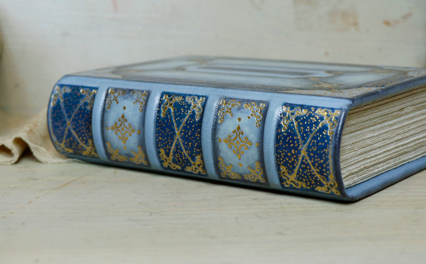 Antiqued baby blue leather journal with gold tooled decoration. Celestial Whisper