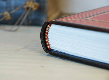 Bright red leather journal with black inlays and gold tooled decoration - The Gilded Labyrinth
