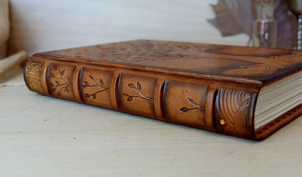 Antiqued brown leather journal with tooled decoration. The Cycle of Life