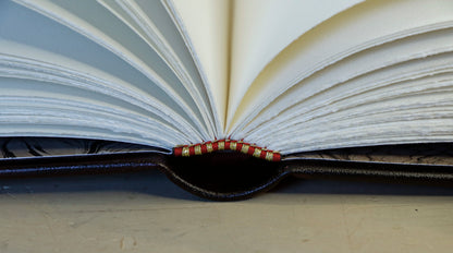 Bright red leather journal with black inlays and gold tooled decoration - The Gilded Labyrinth