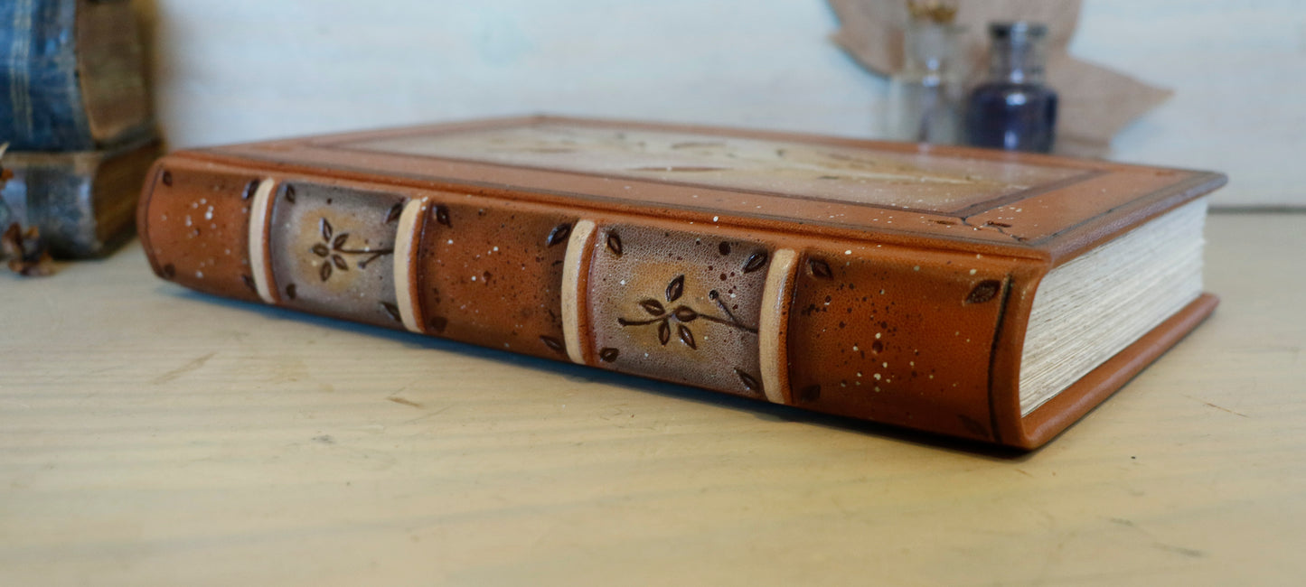 Brown leather journal with tooled floral decoration . Romantic Journey