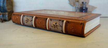 Brown leather journal with tooled floral decoration . Romantic Journey