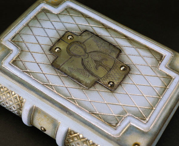 Small leather journal with brass etching of Jesus Christ, white leather with gold tooled decoration, tea stained pages