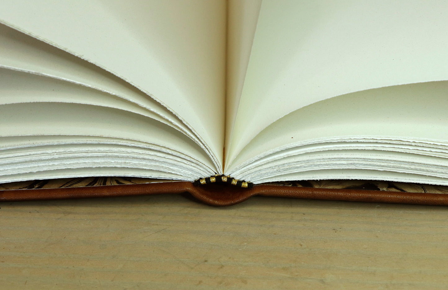 Brown leather journal with tooled decoration, The Circle of Time in Black