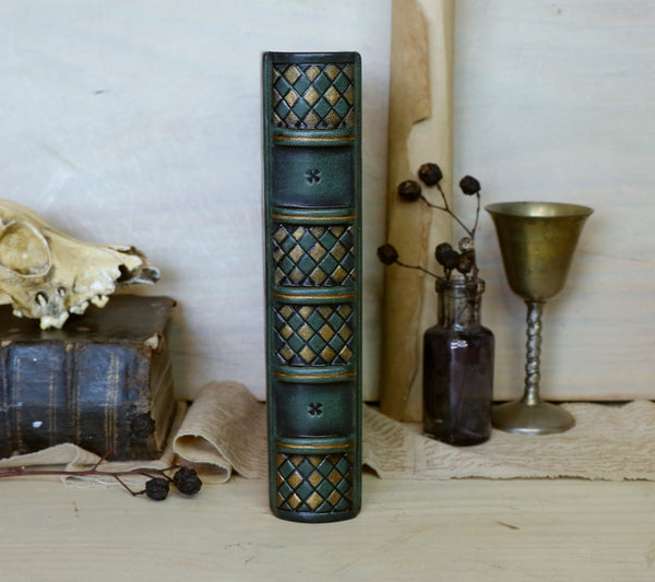 Green leather journal with gold painting and tooled decoration, The Eye of the Universe