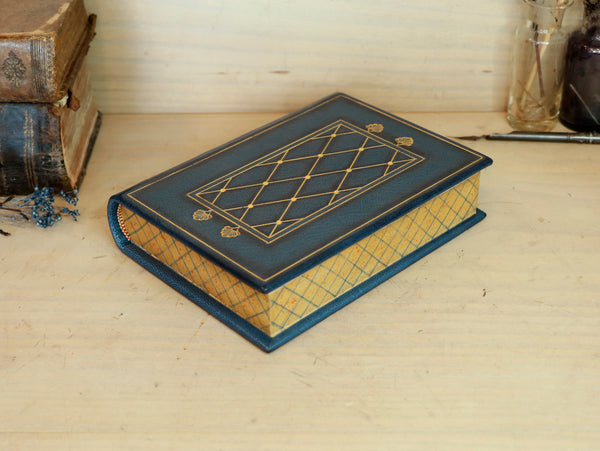 Blue leather journal with gold tooled decoration and painted edges. A Small Treasure