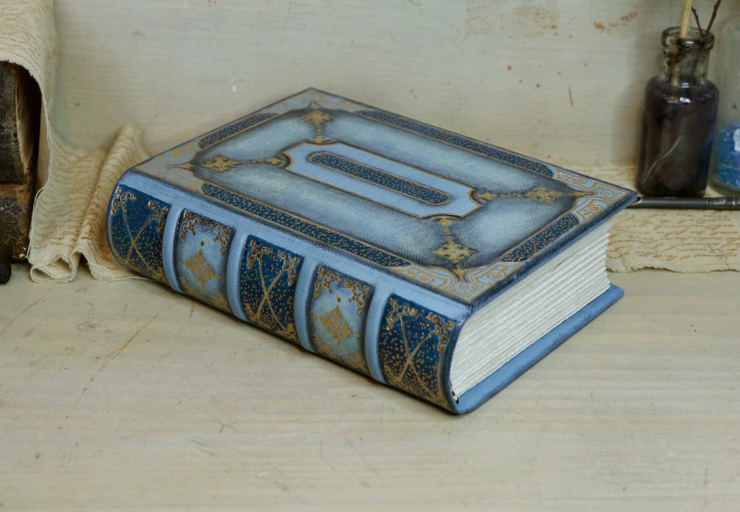 Antiqued baby blue leather journal with gold tooled decoration. Celestial Whisper