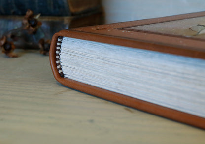 Brown leather journal with tooled floral decoration . Romantic Journey