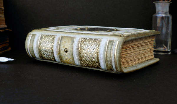 Small leather journal with brass etching of Jesus Christ, white leather with gold tooled decoration, tea stained pages