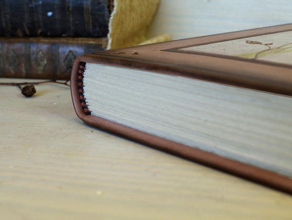 Brown leather journal with tooled floral decoration . Romantic Journey