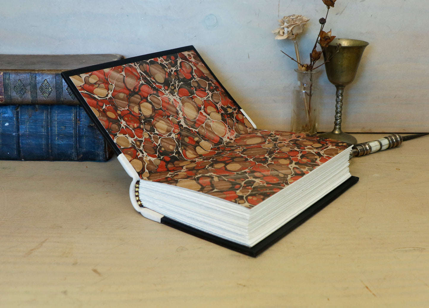 Antiqued journal, Orange-brown leather cover with white leather spine, Gold tooled decoration. The Book of Light