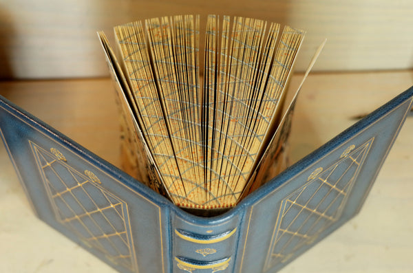 Blue leather journal with gold tooled decoration and painted edges. A Small Treasure
