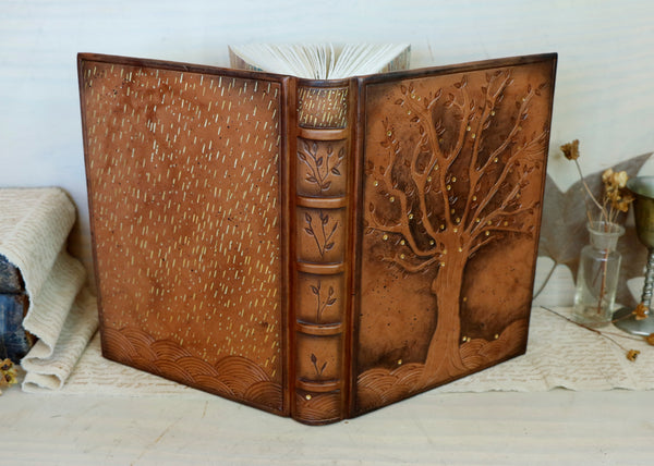 Antiqued brown leather journal with tooled decoration. The Cycle of Life