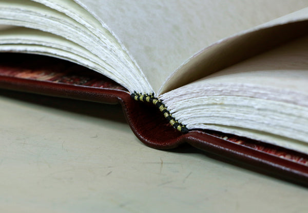 Antiqued red leather journal with cross decoration. One of a Kind - Faith