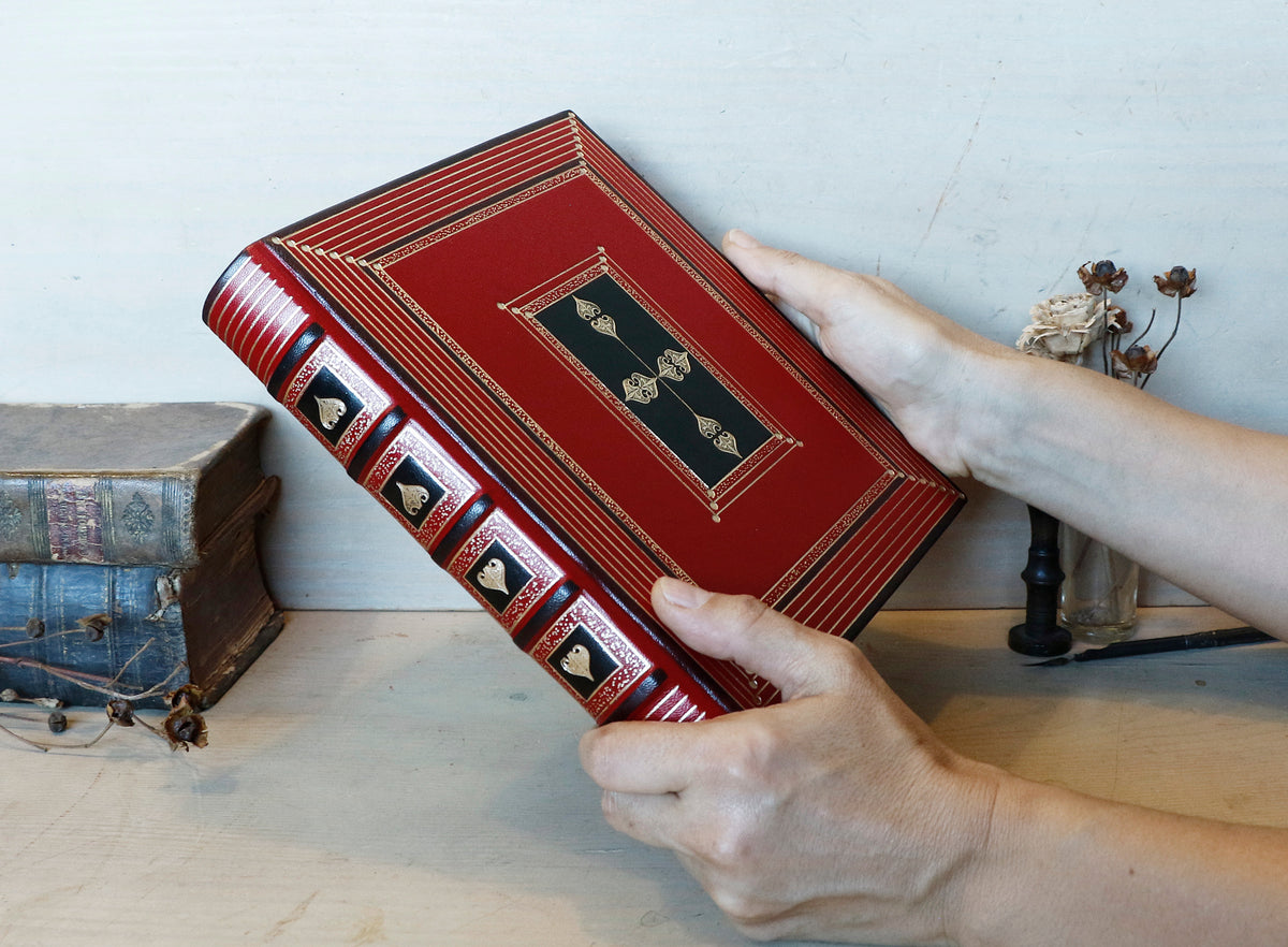 Bright red leather journal with black inlays and gold tooled decoration - The Gilded Labyrinth