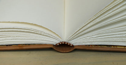 Brown leather journal with tooled and hand painted decoration. Artist paper. Mosslight