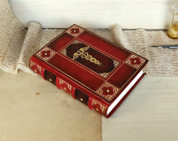Red leather journal with gold decoration - The Caduceus