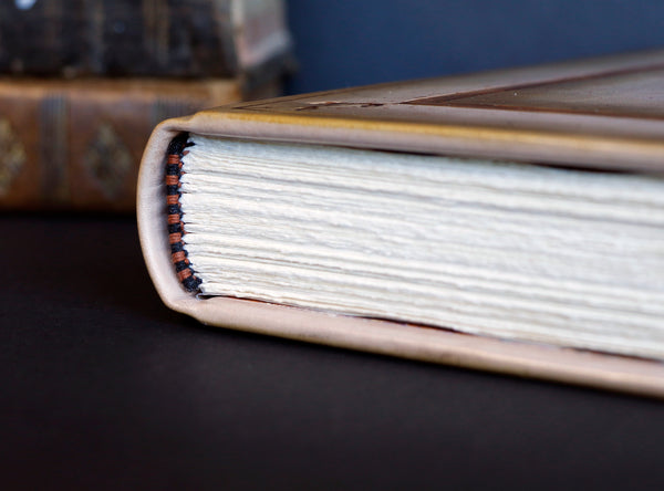 Brown leather journal with tooled floral decoration . Romantic Journey